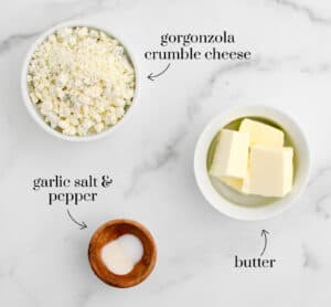 Butter Gorgonzola Garlic Salt Pepper on White Marble Surface