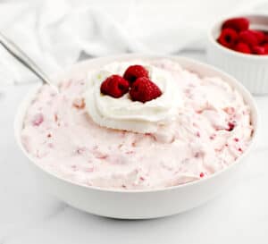 Served in Bowl with Spoon and Fresh Raspberries in a Bowl on Side