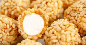Marshmallow Krispies Dipped in Caramel Rolled in Rice Krispies