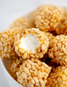 Marshmallow Krispies Dipped in Caramel Rolled in Rice Krispies in a Bowl