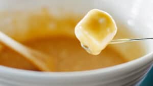 Dipping Marshmallow in Bowl of Caramel