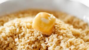 Rolling Caramel Dipped Marshmallow in Rice Cereal