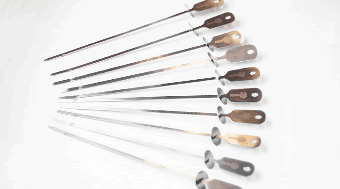 Set of 10 Cave Tool Skewers on White Surface