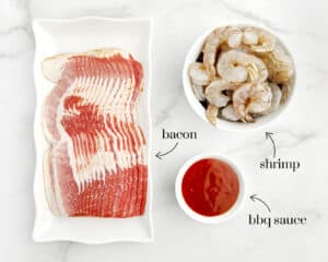 Raw Shrimp, Bacon, and Barbecue Sauce on White Surface