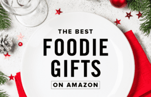 The Best Foodie Gifts on Amazon Text Overlay on White Plate with Red Napkin and Wintery Christmas Table Setting
