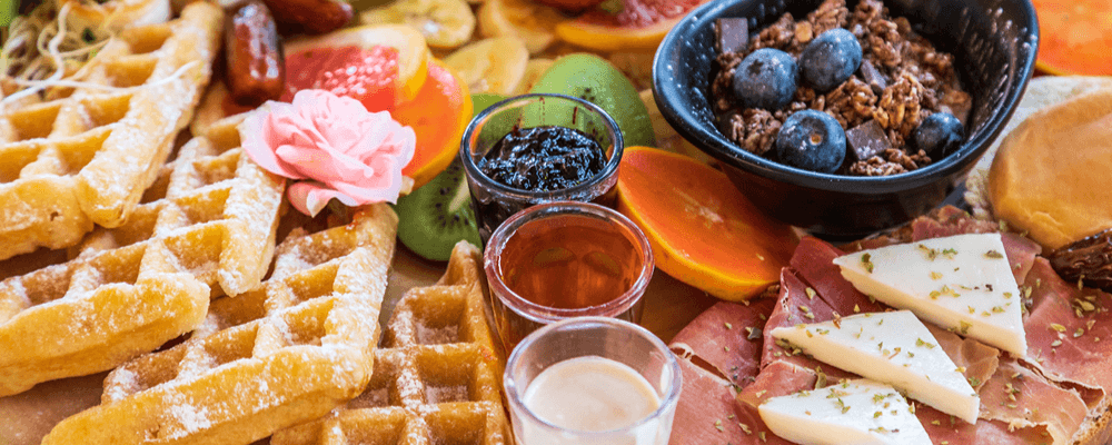 Breakfast Charcuterie Board with Waffles, Jams, Meats, Cheese, Fruits