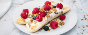 Banana Split Breakfast with Berries, Yogurt, Seeds, and Granola on a Plate