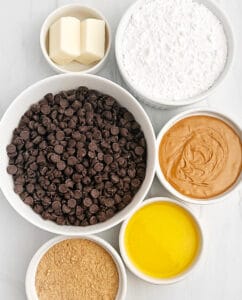 Peanut Butter Cup Ingredients Including Chocolate Chips, Peanut Butter, Butter, Graham Crackers, Powdered Sugar, and Almond Bark