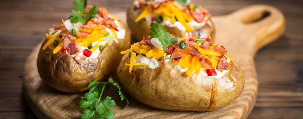 Loaded Baked Potatoes on a Wooden Cutting Board - Side for Meatloaf