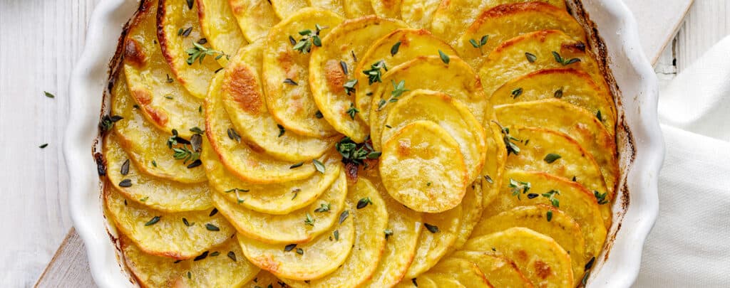 Scallopped Potatoes in a White Baking Dish - Side Dish for Meatloaf