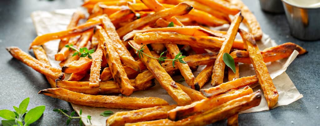 Sweet Potato Fries on a White Platter with Fresh Herbs - Side Dish for Meatloaf