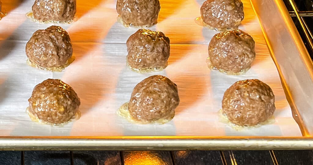 Meatballs on a Baking Sheet Cooking in the Oven