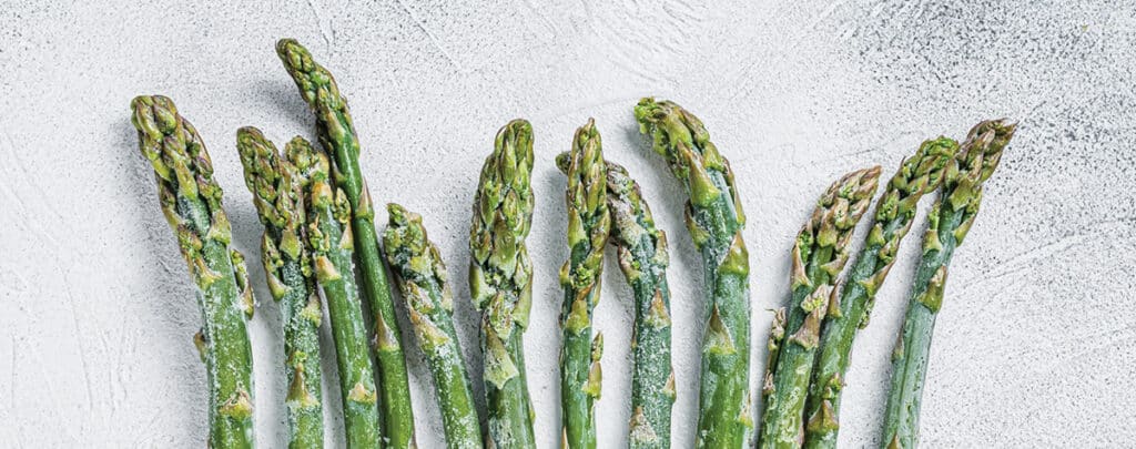 Frozen Asparagus Spears on a White Background