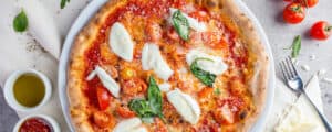 Pizza Sauce on Pizza with Fresh Mozzarella, Herbs, Cherry Tomatoes
