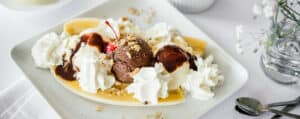 Whipped Cream on Banana Split on a White Square Plate