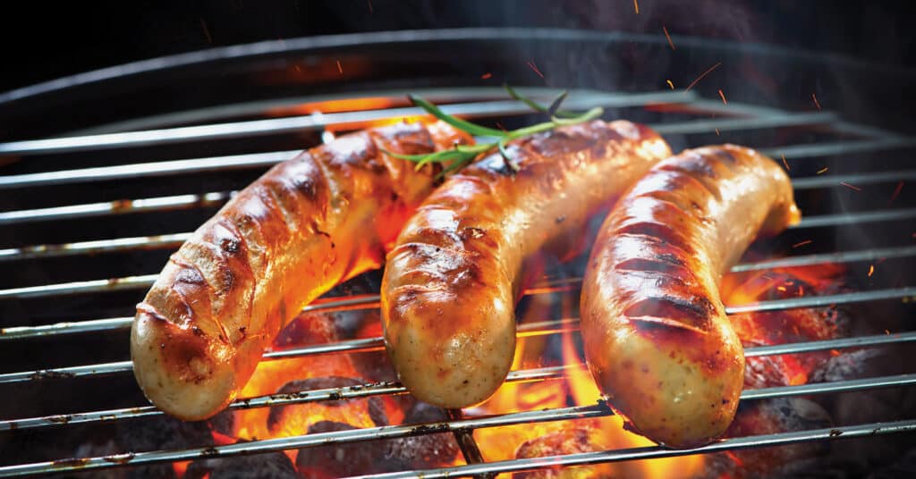 Bratwursts on a Fiery Grill