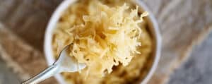 Sauerkraut in a Bowl with a Fork on a Wooden Surface