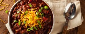 Bowl of Chili with Cheddar Cheese and Green Onions