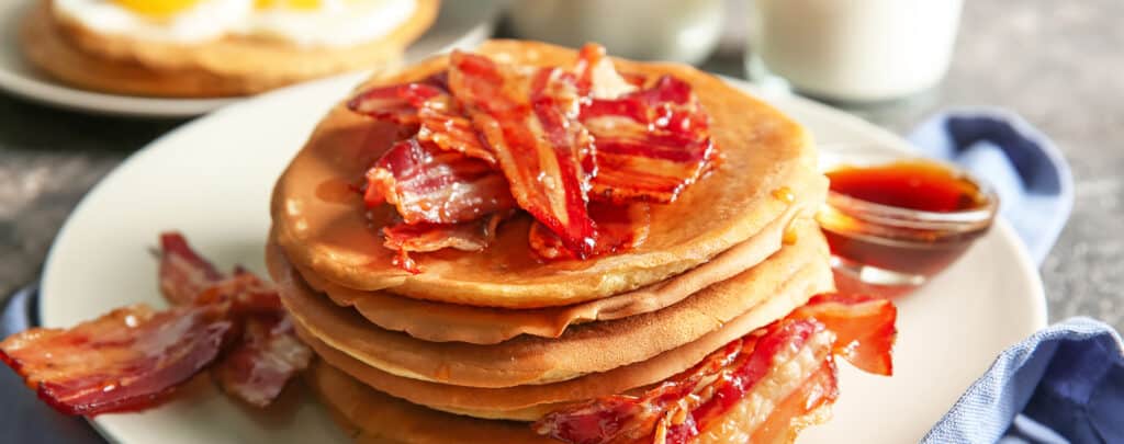 Pancakes Topped with Bacon and Syrup