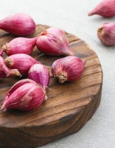 Shallots pm a Wooden Cutting Board