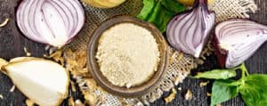 Onion Powder in a Bowl with Fresh Onions Surrounding