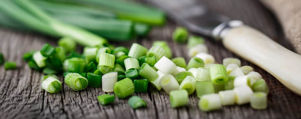 Scallions Sliced on a Dark Countertop