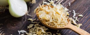Dried Onion in a Spoon on a Dark Countertop