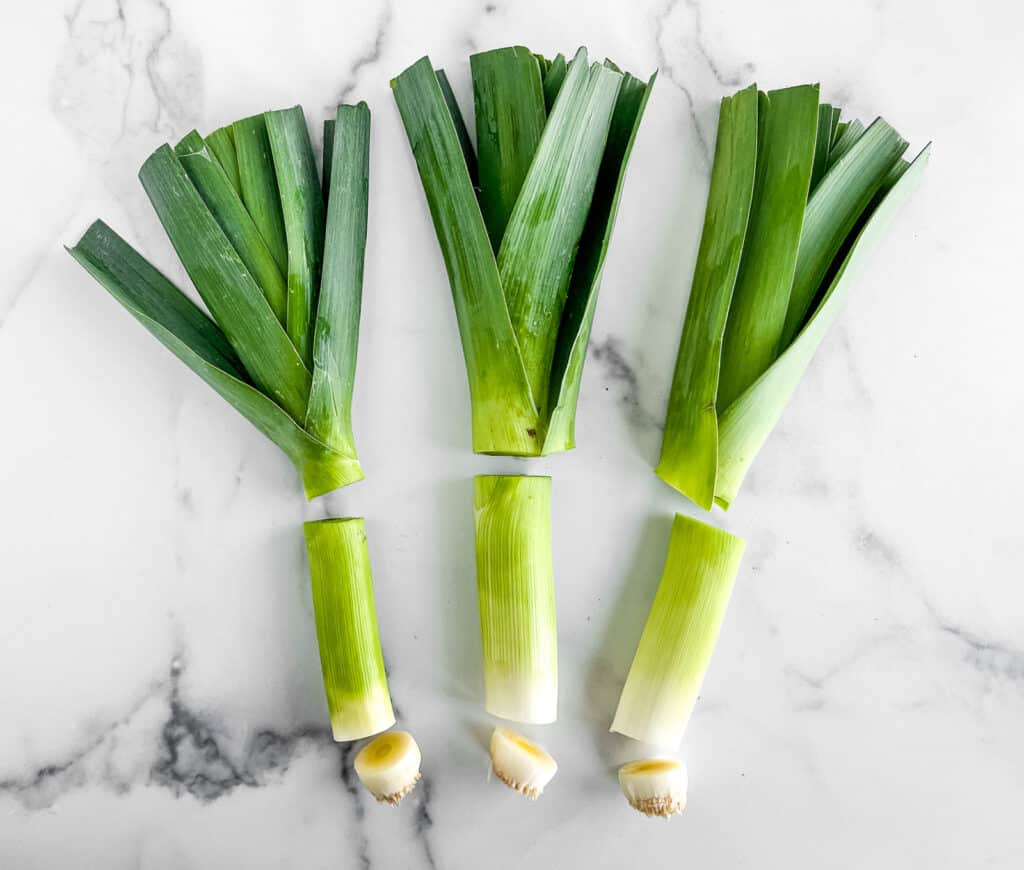 Three Leeks with Dark Green Portion Trimmed from Light Green Portion of Leek