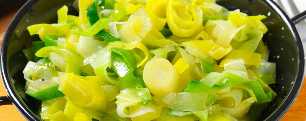 Cooked Leeks in Black Strainer