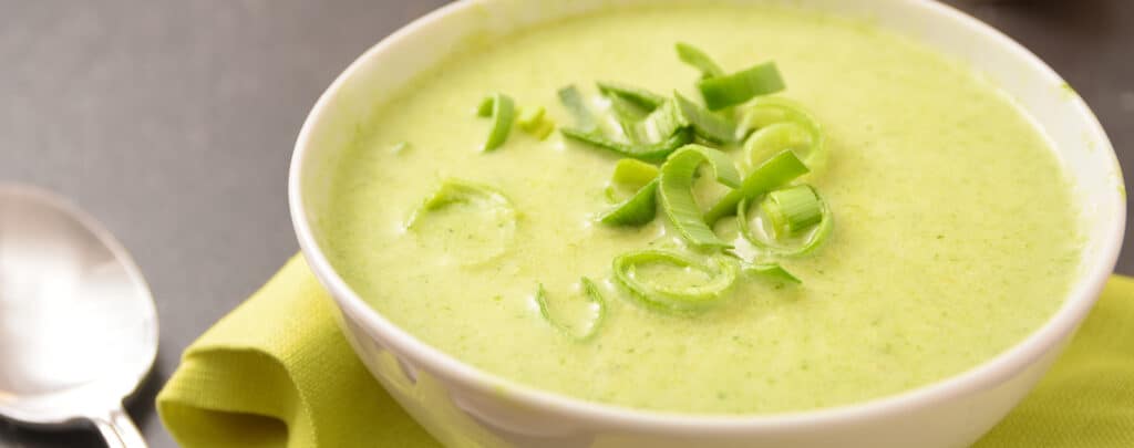 Leek Soup in a White Bowl Garnished with Leeks