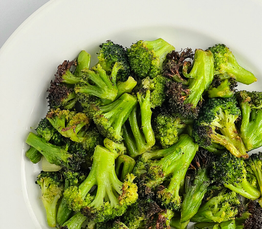 Crisp Delicious Air Fried Broccoli on White Plate