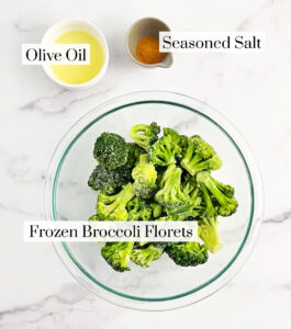 Bowl of Olive Oil, Bowl of Season Salt, Bowl of Broccoli on White Marble Surface