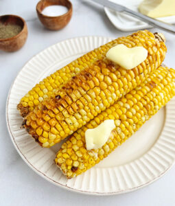 Air Fried Corn on the Cob Topped with Melted Butter on a Plate