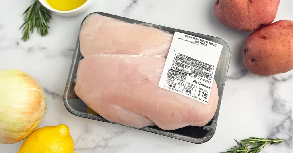 Raw Chicken in Package with Sell By Date or Sell Thru Date with Lemon, Onion, Potatoes, and Rosemary