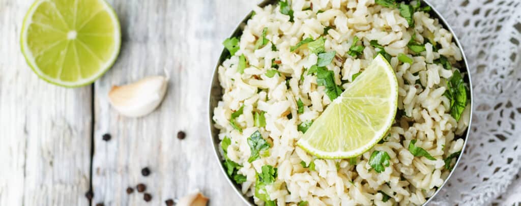 Bowl of Cilantro Lime Rice with Fresh Lime Wedges