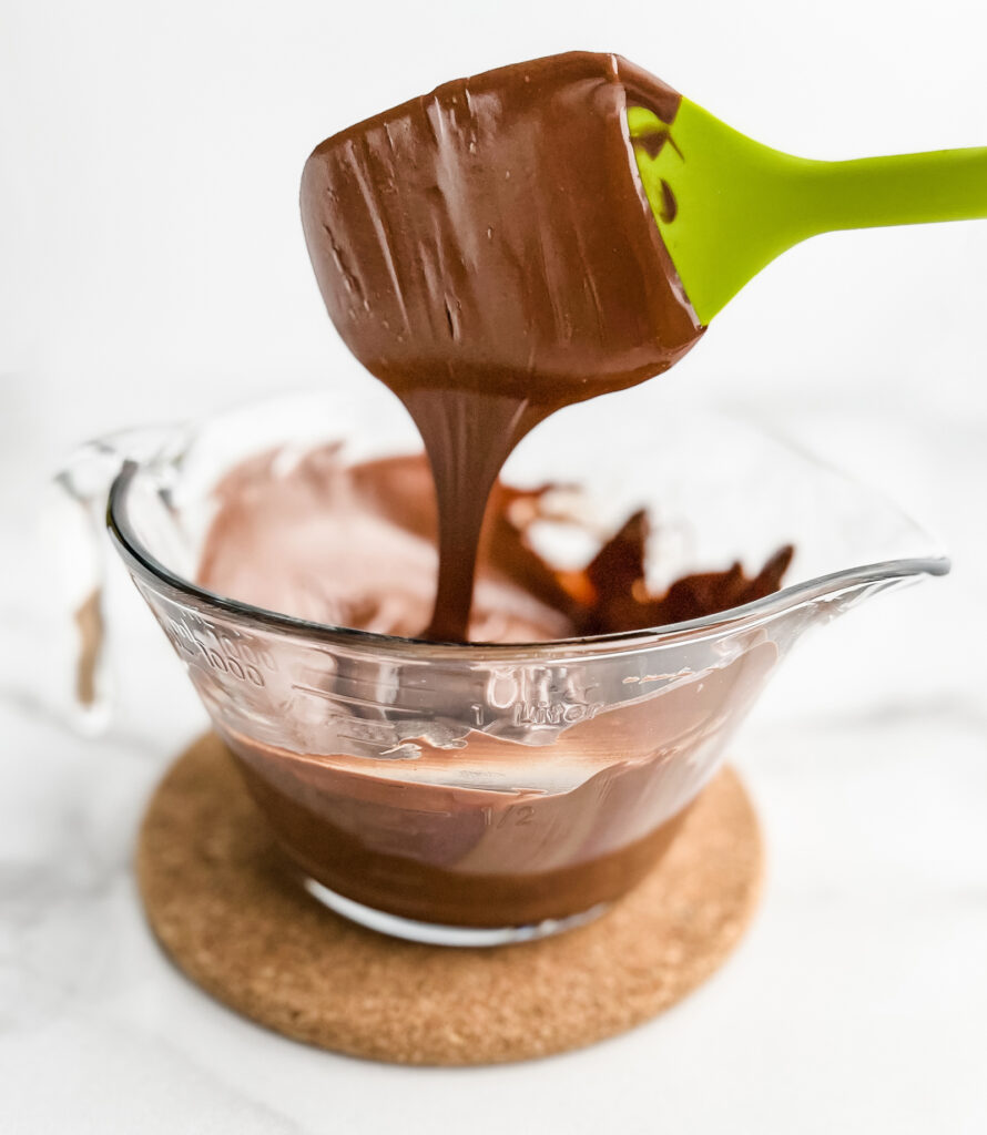 Melted Chocolate in Glass Bowl with Green Spatula