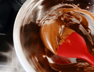 Melted Chocolate in Metal Bowl with Red Spatula