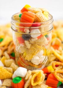 Fall Harvest Treat Mix in Mason Jar with Snack Mix Surrounding