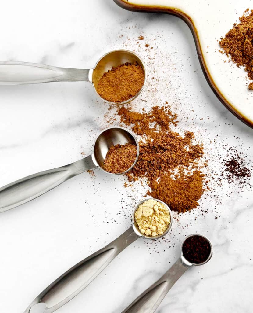 Cinnamon, Nutmeg, Ginger, and Cloves in Measuring Spoons