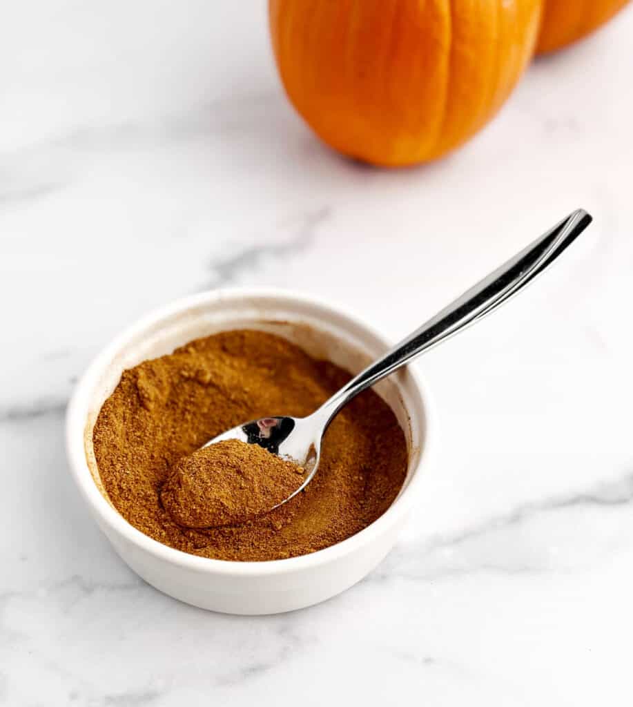 Bowl and Spoon with Mixed Pumpkin Spice on White Marble