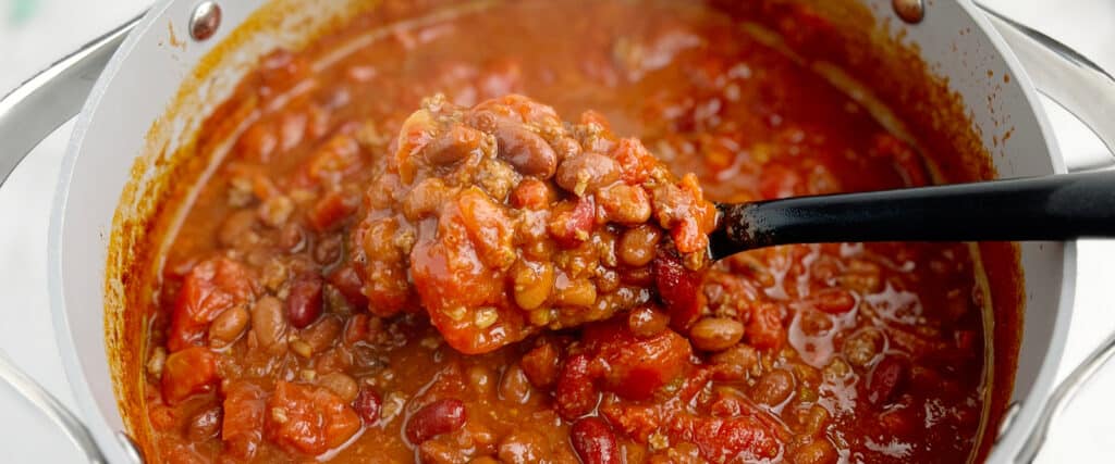 Pot of Chili with Beans, Tomatoes, and Beef with Serving Spoon