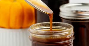 Pumpkin Spice in a mason jar with spoon and pumpkin in background