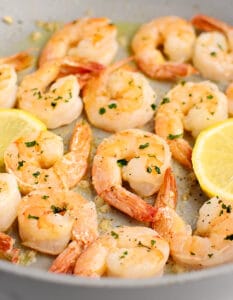 Cooked Shrimp in a Pan with Seasonings, Lemon, and Fresh Parsely