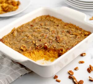 Baked Sweet Potato Casserole in White Baking Dish with Scoop Gone