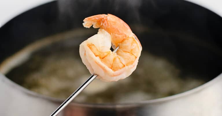 Shrimp on Fondue Stick with Fondue Pot in the Background