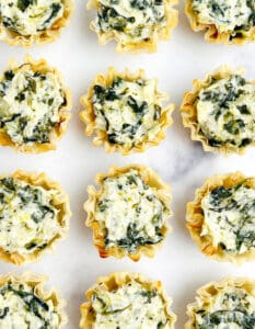 Spinach Artichoke Bites on White Surface