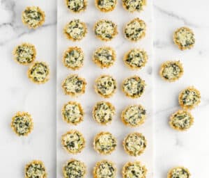 Spinach Artichoke Bites on White Surface