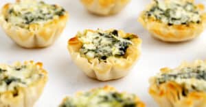 Spinach Artichoke Bites on White Surface