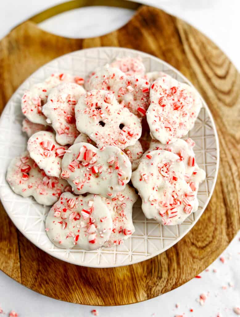 White Chocolate Peppermint Pretzel Crisps on Plate on Wooden Surface