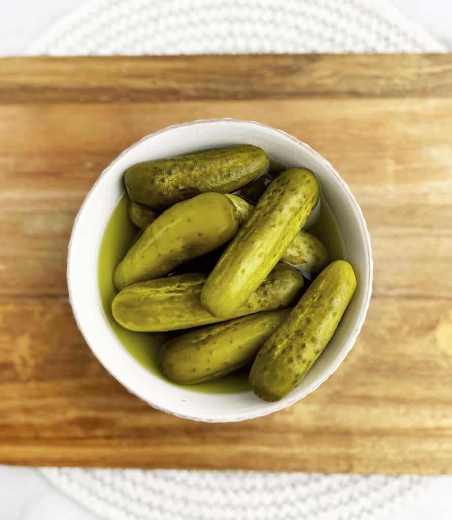 Pickles in Bowl on Wooden Surface